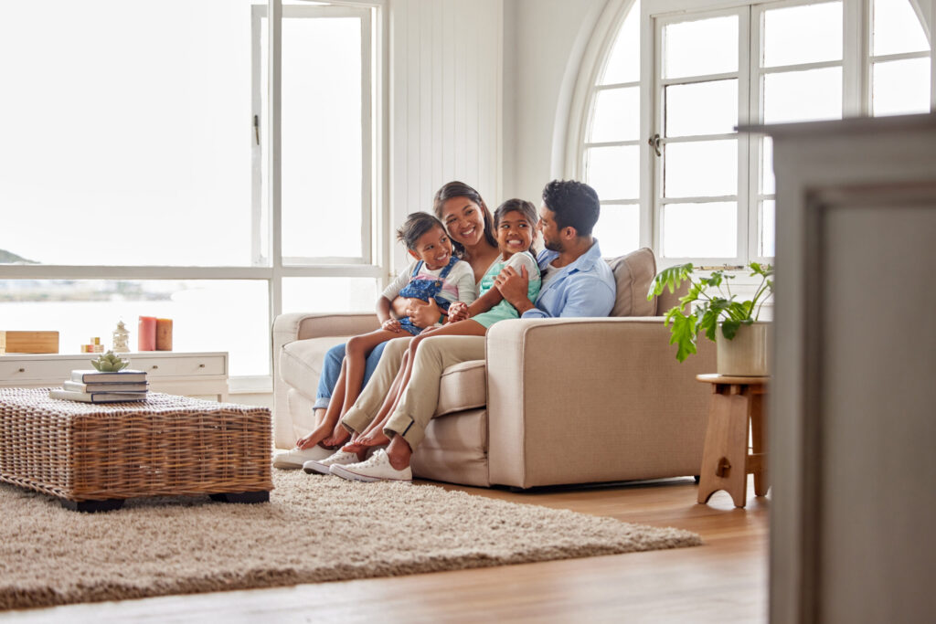 Happy family relaxing at home. Consider air handlers for a comfortable home environment in Miami, FL.